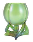 An Austrian Loetz style Art Nouveau green glass vase, the green iridescent glass body supported on