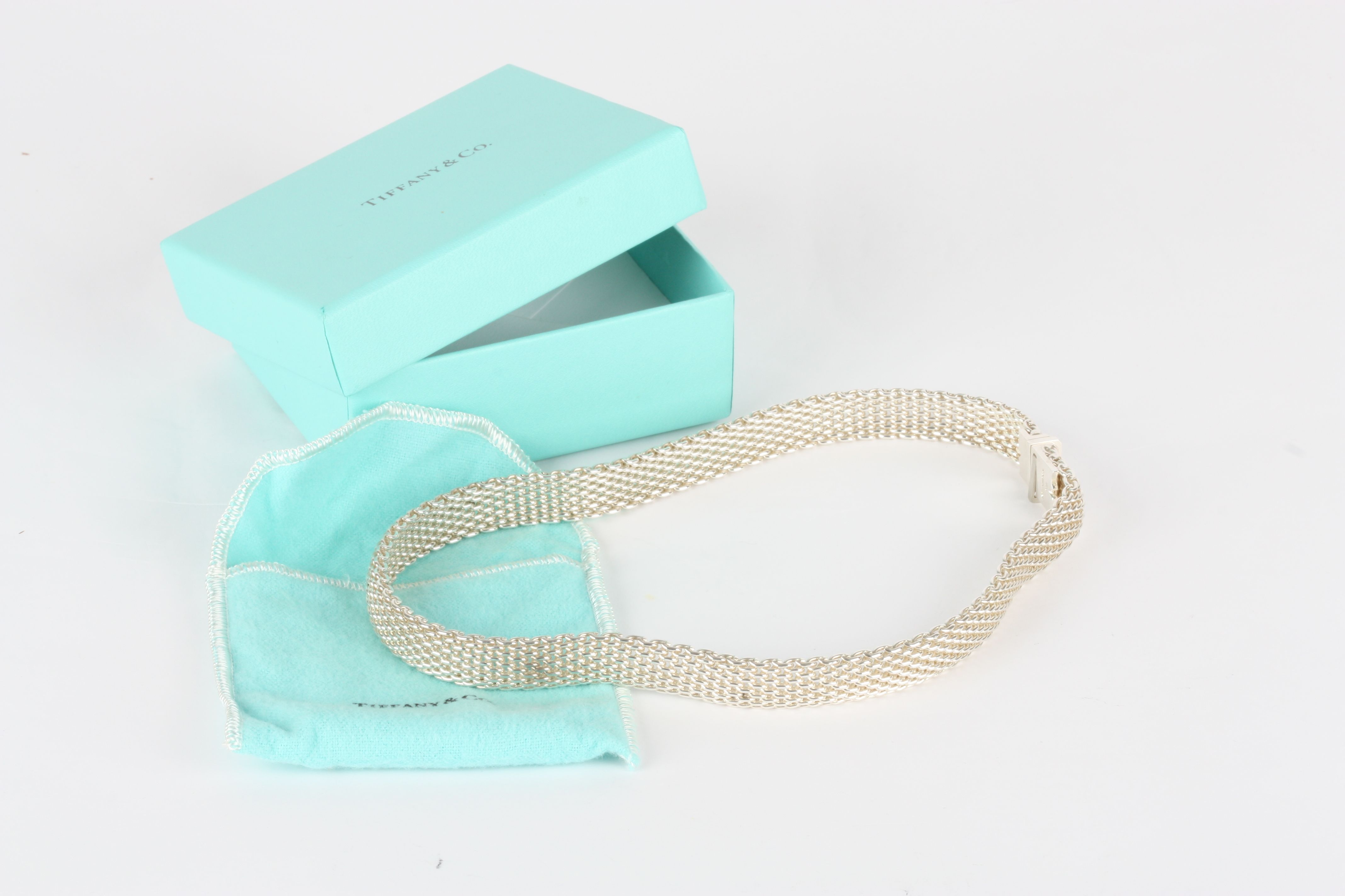 A Tiffany Sterling Silver necklace, of plain linked form, in original gift box, pouch and with