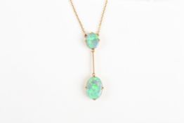 An Edwardian 15ct gold and black opal pendant with large oval opal suspended from a smaller opal,