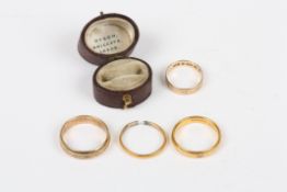 Four assorted gold wedding bands, comprising: 2 x 22ct bands and 2 x 9ct bands, 9ct: 6.9 grams.