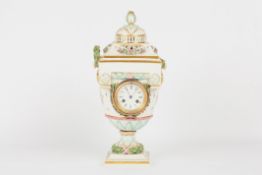 A 19th century Continental porcelain urn shaped clock, with white porcelain dial and French