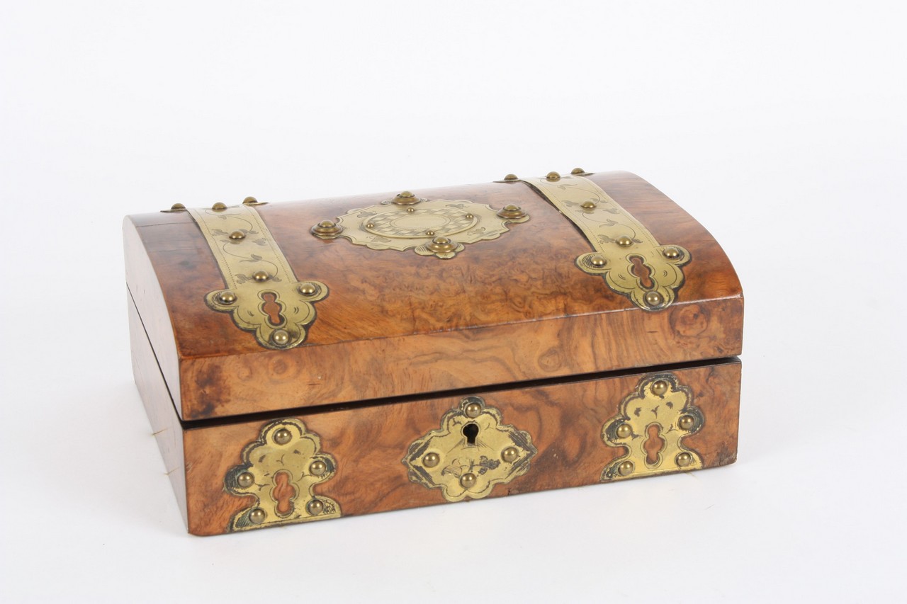 A Gothic walnut jewellery chest, with brass strap work to the lid and sides, with compartmented