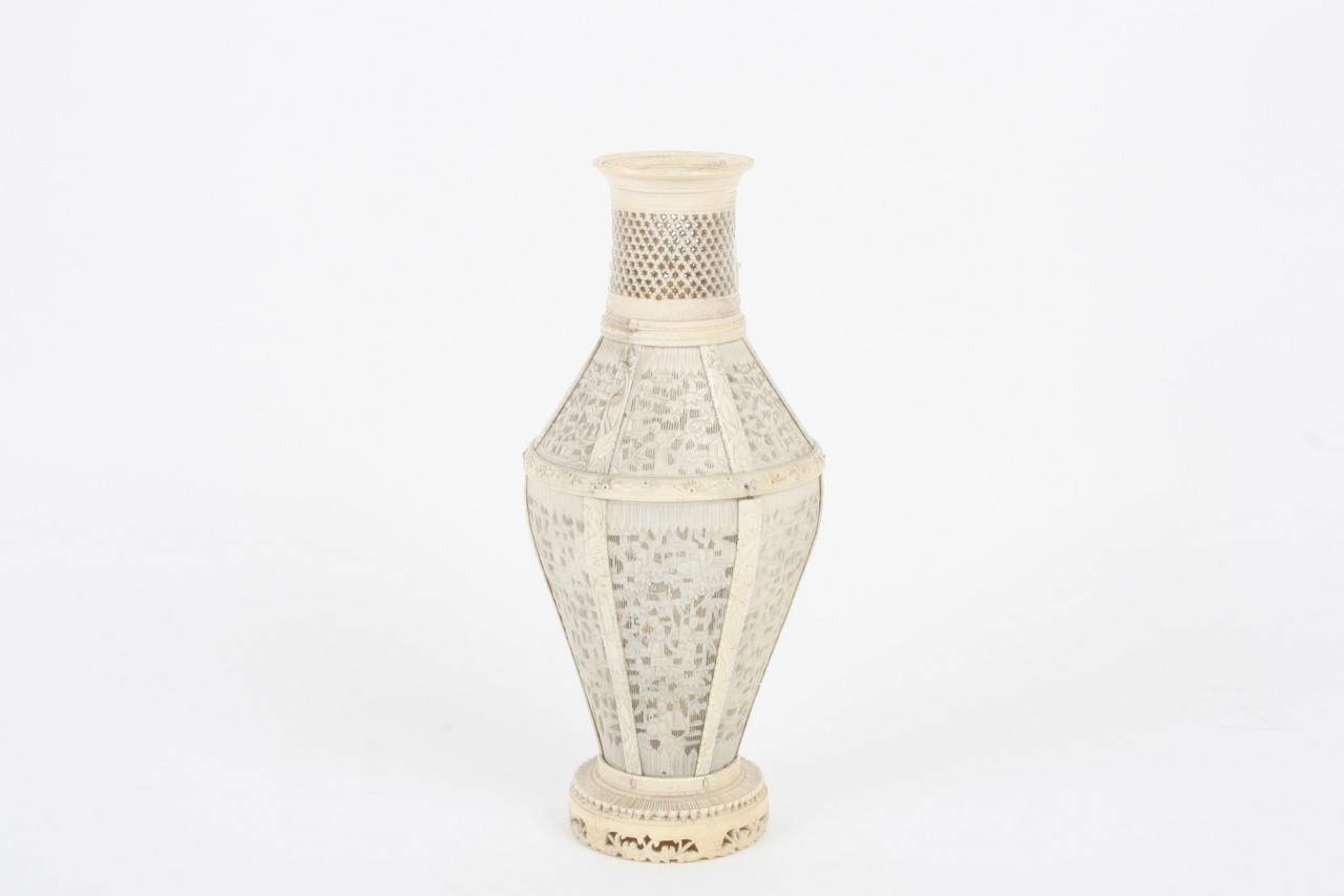 A Chinese mid 19th century ivory vase, the baluster shaped vase with six panels finely pierced and
