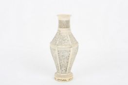 A Chinese mid 19th century ivory vase, the baluster shaped vase with six panels finely pierced and