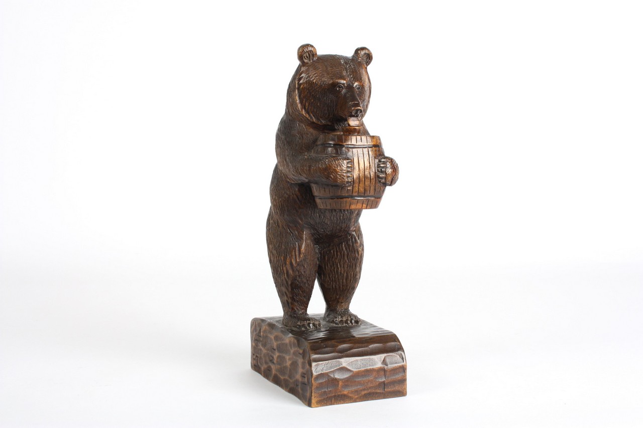 A Black Forrest bear, German, late 19th century, the carved bear standing with opening mouth holding