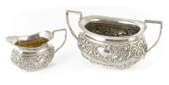 A silver Edwardian sugar basin, silver cream jug hallmarked Birmingham 1906, the basin heavily