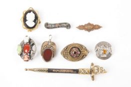 A collection of brooches and pendant, comprising a Victorian garnet brooch, a silver Scottish