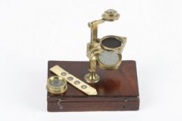A brass pocket microscope by Banks, circa 1820, signed on the brass pillar Banks, Strand London, the