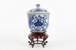 A 19th century Chinese blue and white pot and cover, the bell-shaped body decorated with flowers,