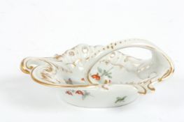 A late 19th century Dresden ring dish, with hand painted flowers, gilt and scroll decoration, with