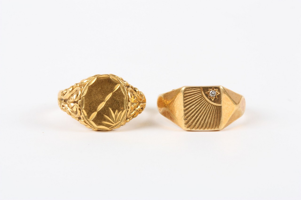 Two gentleman`s 18ct gold signet rings, one with repoussé decoration the other set with small