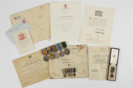 A collection of WW1 and WW2 medals with associated paper work and ribbons for Geoffrey Walker