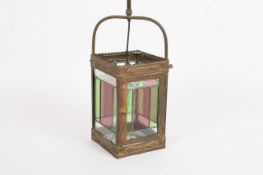 An early 20th century brass and stained glass lamp, of rectangular form, each panel with green and