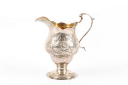 A George III silver cream jug, hallmarked London 1774, the body of bulbous form with later Victorian