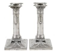 A pair of Victorian silver candlesticks, hallmarked London 1897, with makers initials TB, the