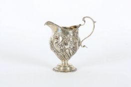 A silver cream jug, Chester 1902, with maker`s initials JDWD for James Deakin and Son`s, the body