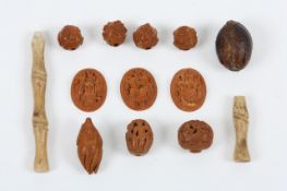 A small collection of hand carved Japanese beads and nut shells, the beads carved predominantly with