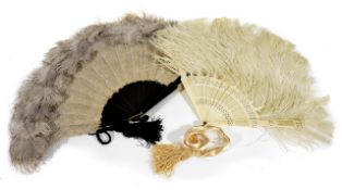 Two other 1920s ostrich feather fans, one with pierced celluloid sticks, the other with wooden