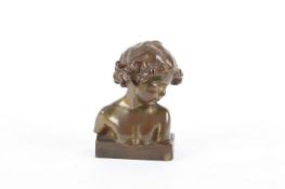 After Camus, A bronze bust of a young child, signed and bearing Goldscheider factory mark. 10cm high