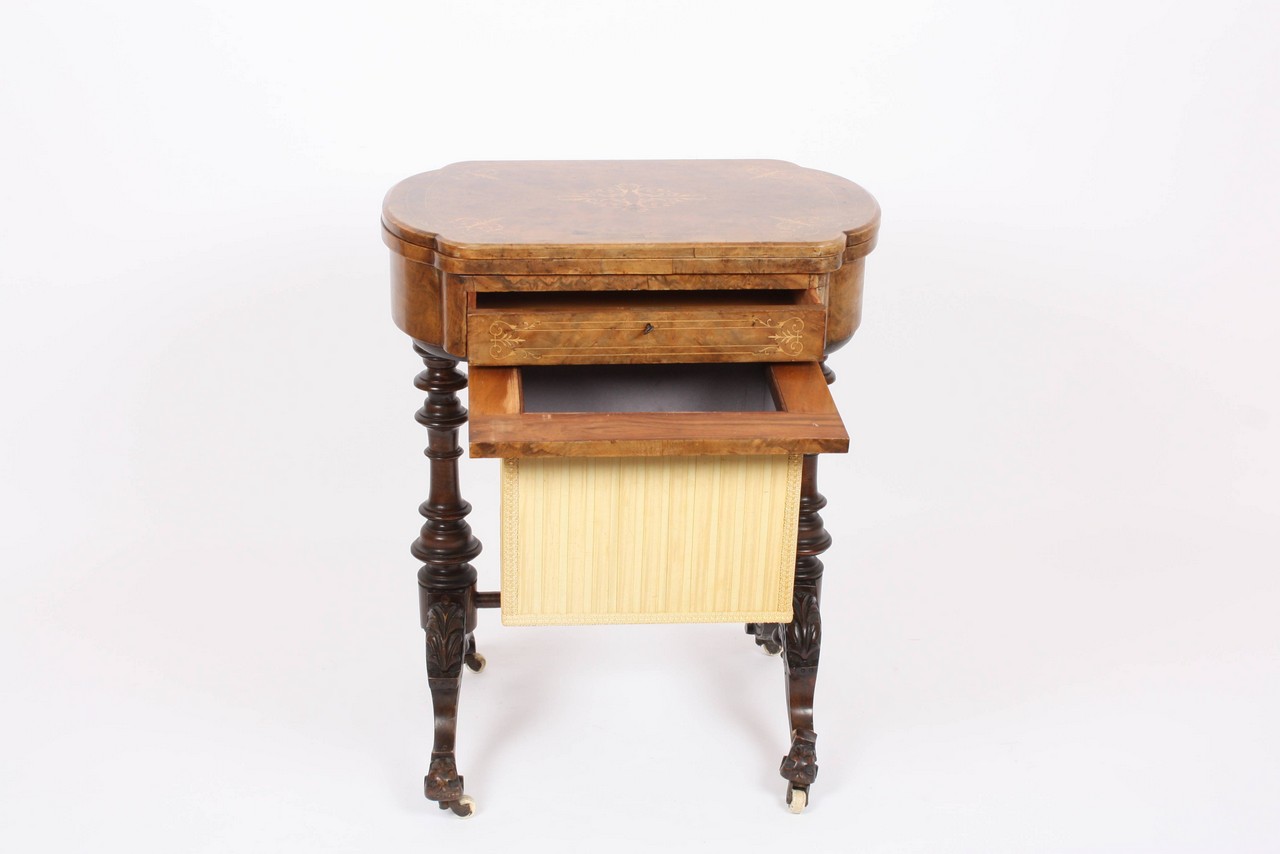 A Victorian figured walnut games/work table, the inlaid hinged swivel top opening to reveal chess