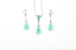 A jade coloured pendant and earring set, the carved pendant on silver and marcasite chain link