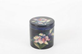 A Moorcroft Orchid preserve pot, the tubelined body decorated with alternating purple and pink