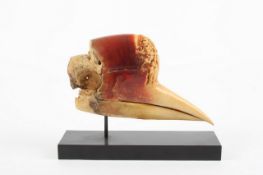 A 19th century Chinese carved hornbill skull, finely carved with a scene of a figure on horse back