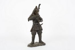 A 20th century bronze figure of a Japanese warrior, the standing figure holding a sword. 48cm high