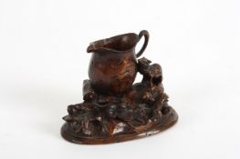 An interesting 19th century treen group, of rats ferreting around a cream jug amongst foliage,