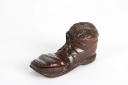 A 19th century treen inkwell in the shape of an old boot, inscribed around the rim Montreux with