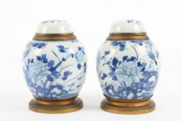 A pair of 19th century Chinese blue and white ginger jars and covers, each decorated with