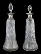 A pair of silver topped glass decanters, hallmarked Birmingham 1938/39, the tapered bodies with