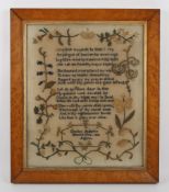 An unusual sampler dated 1856 worked by a gentleman, with three verse poem surrounded by flowers and