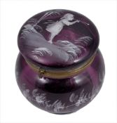 A 19th century Mary Gregory purple glass powder jar and cover, with white enamel decoration of a