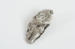 A Japanese silver coloured metal money/paper clip, Modern, the hinged clip with moulded dragon,