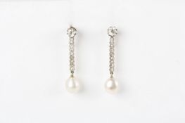 A pair of 1920s teardrop pearl and diamond earrings, on diamond studs with diamond stems terminating