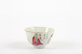 A small 19th century Chinese tea bowl, painted with famille rose figures and cartouche panels with