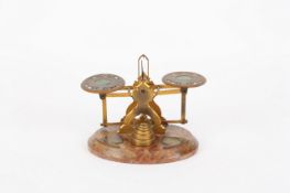 A brass set of scales and weights, possibly Continental, late 19th century, the brass pans with
