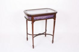 An Edwardian mahogany bijouterie cabinet, the satinwood banded glazed rising top above glazed