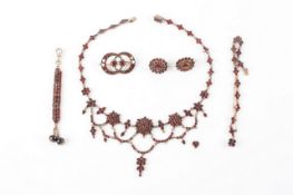 A 19th century bohemian garnet suite jewellery, comprising necklace with drop pendants attached,