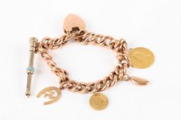 A Victorian 9ct gold curb link charm bracelet, on padlock clasp with five charms attached