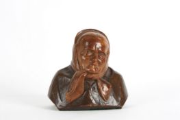 A carved wooden figure of an elderly lady, probably Continental, realistically carved from two