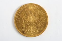 An Austrian 100 corona 1915 gold coin, 33.8 grams Some wear, dented rim.