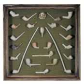 A glazed display case decorated with selection of clay pipes, In good overall condition