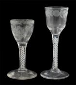 Two 18th century opaque twist stem cordial glasses, both bowls engraved with flowers and foliage,