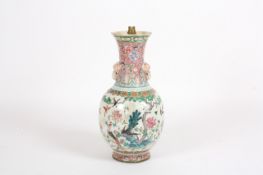 A large 19th century Chinese famille rose vase, with elephant handles, the body ornately decorated
