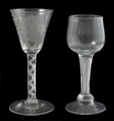 Two 18th century air twist stem drinking glasses, one with tapered bowl engraved with leaves, grapes