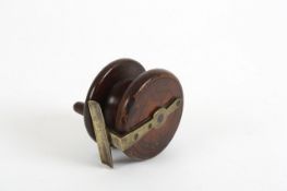 A brass mounted rosewood fishing reel by L.Lock & Co. 7.5cm wide In good overall condition