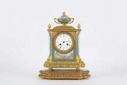 A porcelain mounted ormolu mantel clock, French, circa 1880, with a 3 3/4- inch enamel dial with