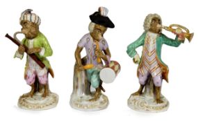 A set of three Samson porcelain monkey band figures, 19th century, one playing the trumpet, one
